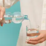 woman_pouring_water_into_glass_23_2148728795